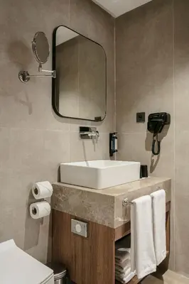 a bathroom with a sink and a mirror at NearYo Hotels in Marrakech