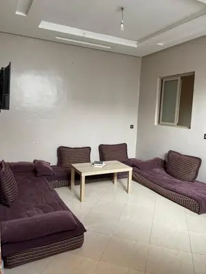 a living room with purple couches and a table at Marrakech,Massira1 in Marrakech
