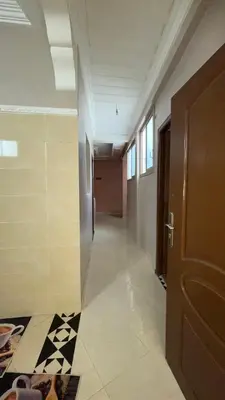 an empty hallway with a door and a tile floor at Marrakech,Massira1 in Marrakech