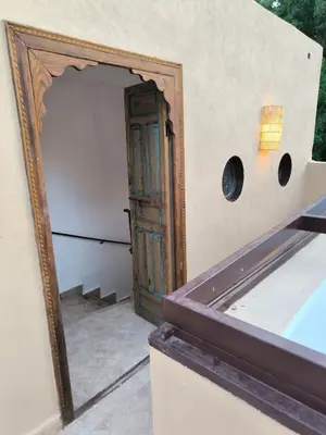 an open door into a room with a mirror at Riad MAGE Marrakech in Marrakech