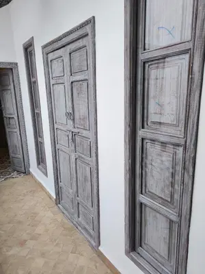 an empty room with two doors on a wall at Riad MAGE Marrakech in Marrakech