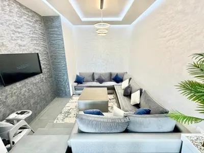 a living room with a couch and a tv at Villa exclusive Ourika piscine sans vis-à-vis in Segraga