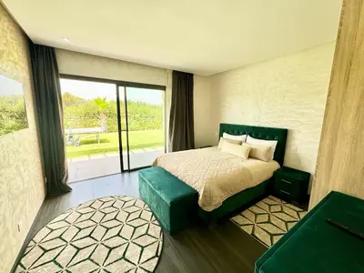 a bedroom with a bed and a large window at Villa exclusive Ourika piscine sans vis-à-vis in Segraga