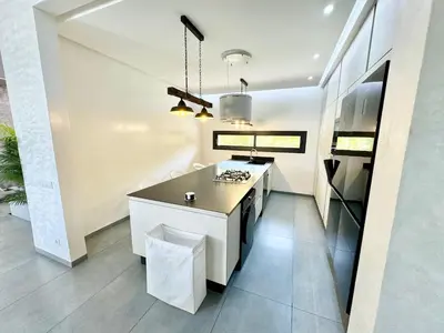 a kitchen with a island in the middle of a room at Villa exclusive Ourika piscine sans vis-à-vis in Segraga