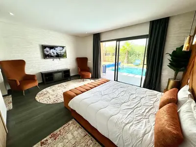 a bedroom with a bed and a living room at Villa exclusive Ourika piscine sans vis-à-vis in Segraga
