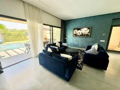 a living room with two couches and a table at Villa exclusive Ourika piscine sans vis-à-vis in Segraga