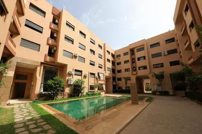 a courtyard of an apartment building with a swimming pool at 2 Bedroom flat - Marrakech in Marrakech