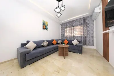 a living room with a blue couch and a table at 2 Bedroom flat - Marrakech in Marrakech