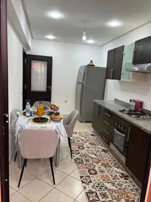 a kitchen with a table with a plate of food on it at Super apt plein centre de Gueliz hyper bien placer pour votre séjour tout à proximité resto café transport in Marrakech