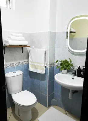 a bathroom with a toilet and a sink at Bright Modern Apartment Marrakech City Center, Walk Everywhere in Marrakech