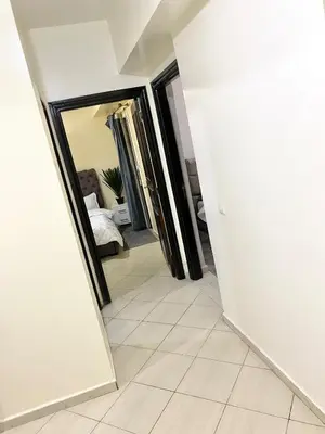 a hallway with a mirror and a room with a bed at Bright Modern Apartment Marrakech City Center, Walk Everywhere in Marrakech