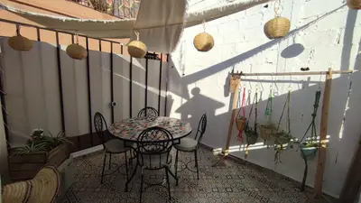 a patio with a table and chairs on a balcony at Maison en exclusivité 2 chambre Place Jemma El Fna in Marrakech