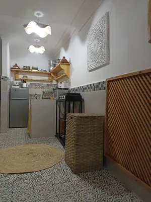 a kitchen with a table and a counter top at Maison en exclusivité 2 chambre Place Jemma El Fna in Marrakech