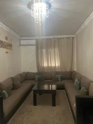 a living room with a couch and a coffee table at appartement sadaa in Marrakech