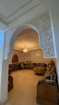 an archway in a building with tables and a room at VILLA MARRAKECH - Centre Ville in Marrakech