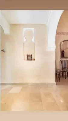 an empty room with a clock on a wall at Résidence riad jawhara in Marrakech