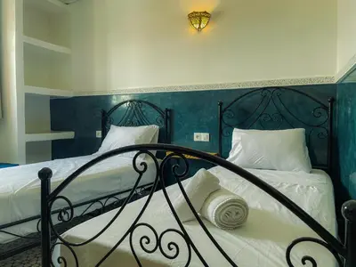 a bedroom with a bed with a wrought iron railing at Antaki retreat Marrakech in Marrakech