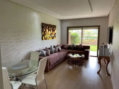 a living room with a couch and a glass table at Le villagois in Marrakech