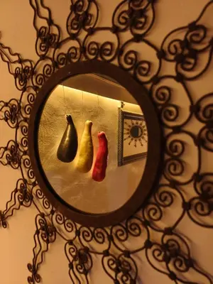 a mirror with three vases hanging on a wall at maison Noé , chambre au rez de chaussée ,un lit double, sale de bain privative séparer in Marrakech