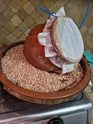 a loaf of bread sitting on top of a table at maison Noé , chambre au rez de chaussée ,un lit double, sale de bain privative séparer in Marrakech