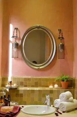 a bathroom with a sink and a mirror on the wall at Palmeraie Stay - Pool & Lake in Marrakech