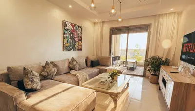 a living room with a couch and a table at Central Cozy Kesh - Pool - Terrace in Marrakech
