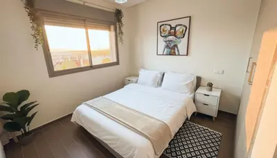 a bedroom with a white bed and a window at Central Cozy Kesh - Pool - Terrace in Marrakech