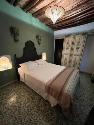 a bedroom with a large bed in a room at Riad Miliana in Marrakech