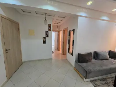 a living room with a couch and a hallway at Appartement Meublé 2 Chambres avec Wi-Fi Haut Débit in Marrakech