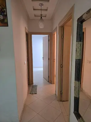 a hallway with a view of an empty room with a door at Appartement Meublé 2 Chambres avec Wi-Fi Haut Débit in Marrakech