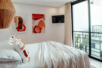 a bedroom with a white bed and a large window at Luxury 4 bed apartment In the heart of Guilez! in Marrakech