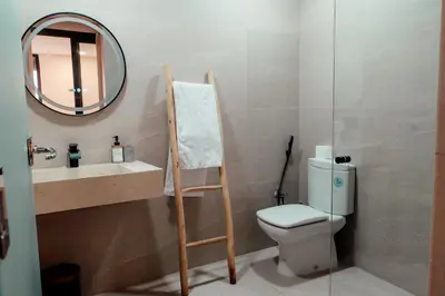 a bathroom with a toilet and a sink and a mirror at Luxury 4 bed apartment In the heart of Guilez! in Marrakech