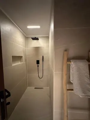 a small bathroom with a shower with a hose at Luxury 4 bed apartment In the heart of Guilez! in Marrakech