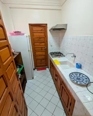 a kitchen with a sink and a refrigerator at Duplex Marakech Dotea Lilia in Marrakech
