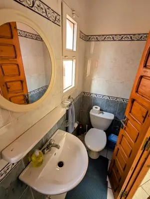 a bathroom with a sink and a toilet and a mirror at Duplex Marakech Dotea Lilia in Marrakech