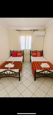 two beds sitting in a room with at Duplex Marakech Dotea Lilia in Marrakech