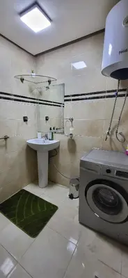 a bathroom with a washing machine and a sink at Cozy Duplex in downtown Marrakesh- 7mn from Gueliz in Marrakech