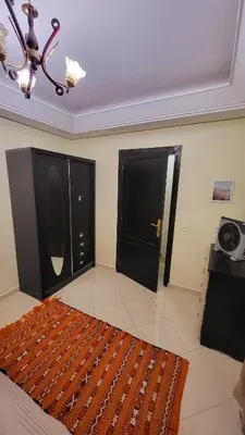 a room with two black doors and a rug at Cozy Duplex in downtown Marrakesh- 7mn from Gueliz in Marrakech
