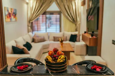 a bowl of fruit on a table in a living room at Appart Duplex 3ch Piscine in Marrakech