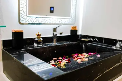 a bathroom with a sink with flowers on it at Appart Duplex 3ch Piscine in Marrakech