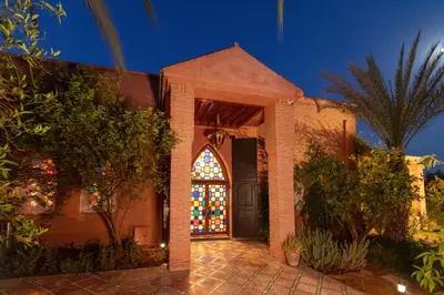 a church with a stained glass window at night at L Mansion Villa in Najem