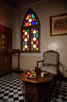 a room with a table and a stained glass window at L Mansion Villa in Najem
