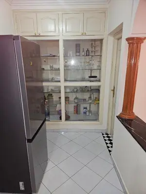 a kitchen with a refrigerator in front of a window at Machaalah gueliz in Marrakech
