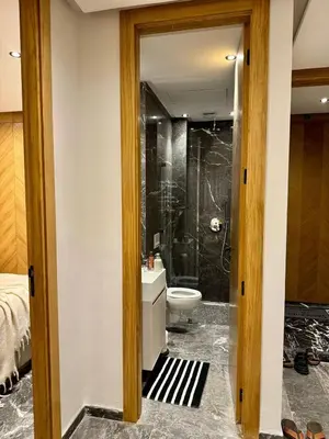 a bathroom with a shower and a toilet and a sink at Marrakech Elite Garden, moderne, chaleureux, tout équipé in Marrakech