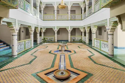 a large hall with a fountain in the middle of a building at Pickalbatros SUNGO Club - All Inclusive in Marrakech