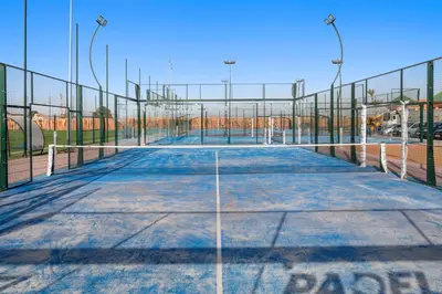 an empty tennis court with a fence around it at Pickalbatros SUNGO Club - All Inclusive in Marrakech