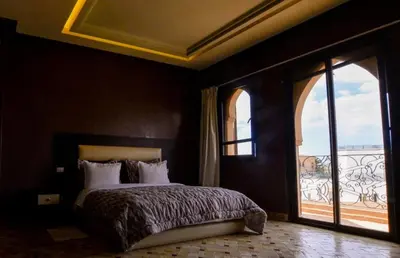 a bedroom with a bed and a large window at Luxury Villa in Marrakech