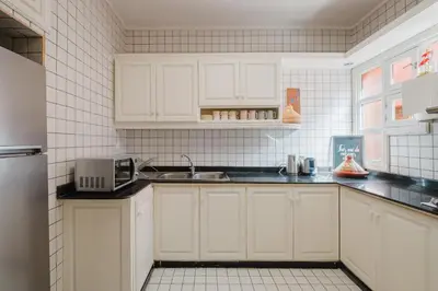 a kitchen with white cabinets and a sink at Confort Spacieux a Hivernage 3 Chambres and Piscine in Marrakech