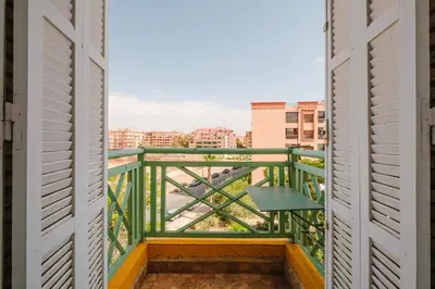 a balcony with a view of a city at Confort Spacieux a Hivernage 3 Chambres and Piscine in Marrakech