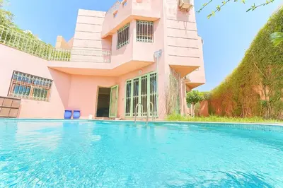 a house with a swimming pool in front of it at Élégante Villa 3 Chambres avec Jardin & Piscine Targa Afak Marrakech in Marrakech
